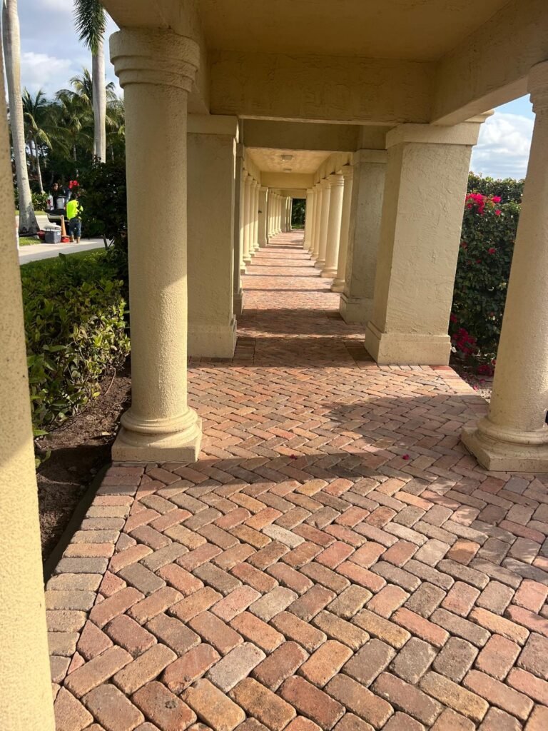 Herringbone brick pavers under a covered colonnade after cleaning