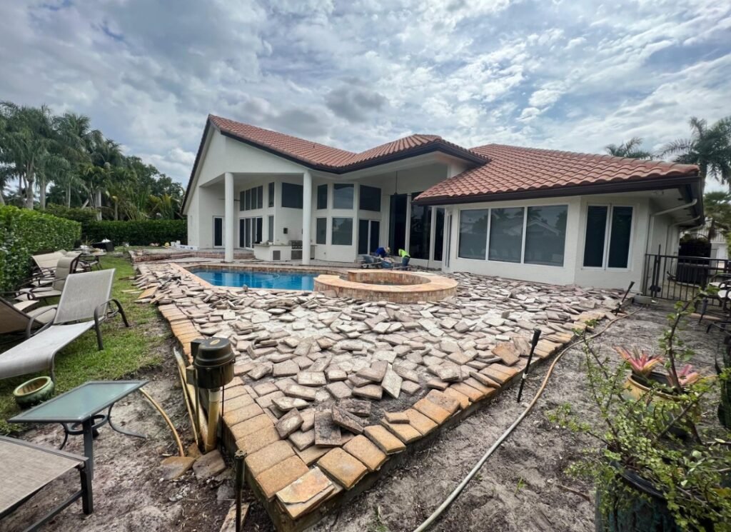 Old pool deck pavers torn up before the repair