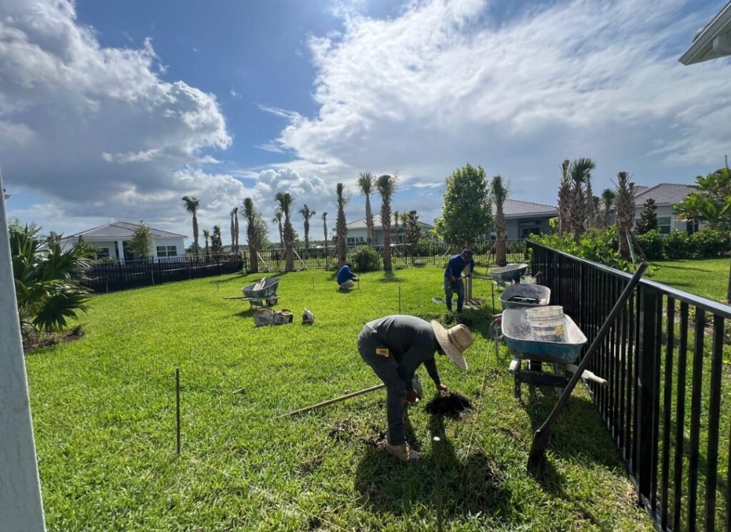 Crew preparing a backyard for artificial grass
