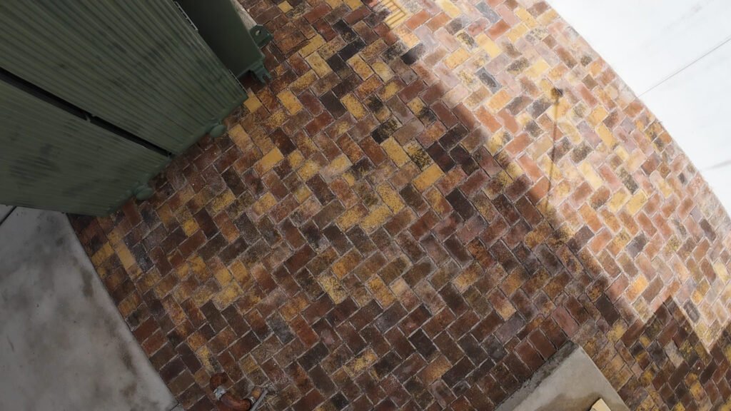 Curved run of herringbone brick pavers on a Boca Raton job