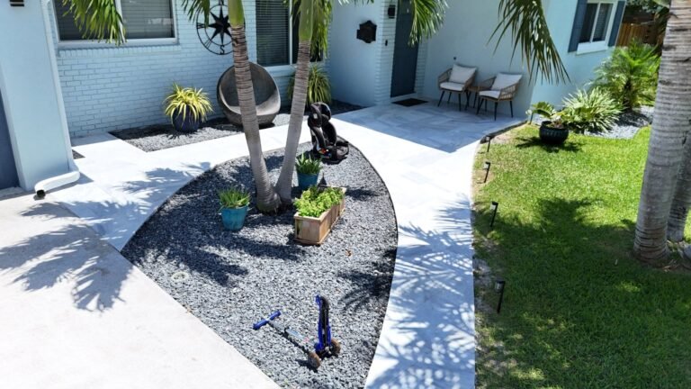 Drone view of a curved light paver front walkway around a garden bed in Boca Raton, FL