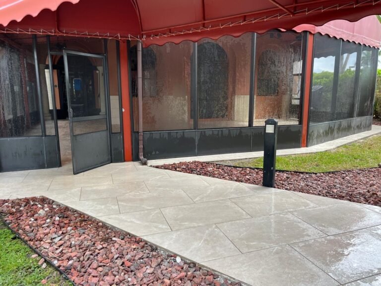 Large porcelain paver walkway leading to a screened commercial patio