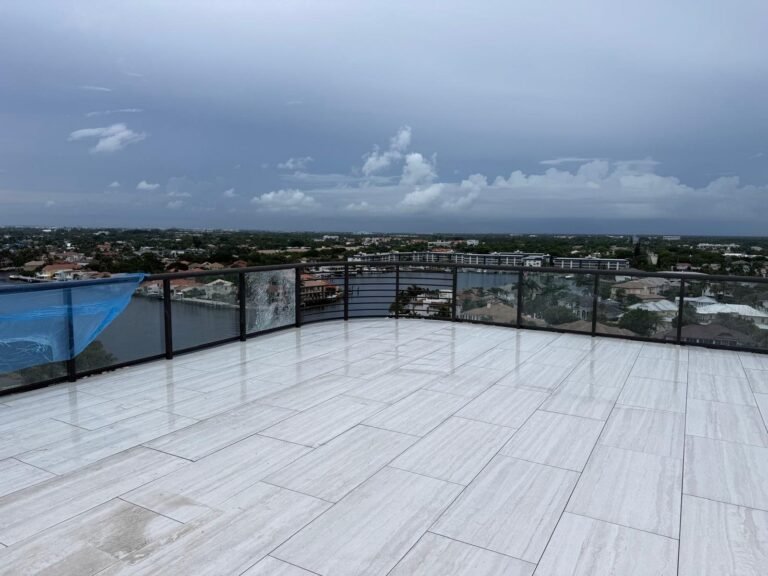 Porcelain paver rooftop terrace with glass railing and a waterfront view in Delray Beach, FL